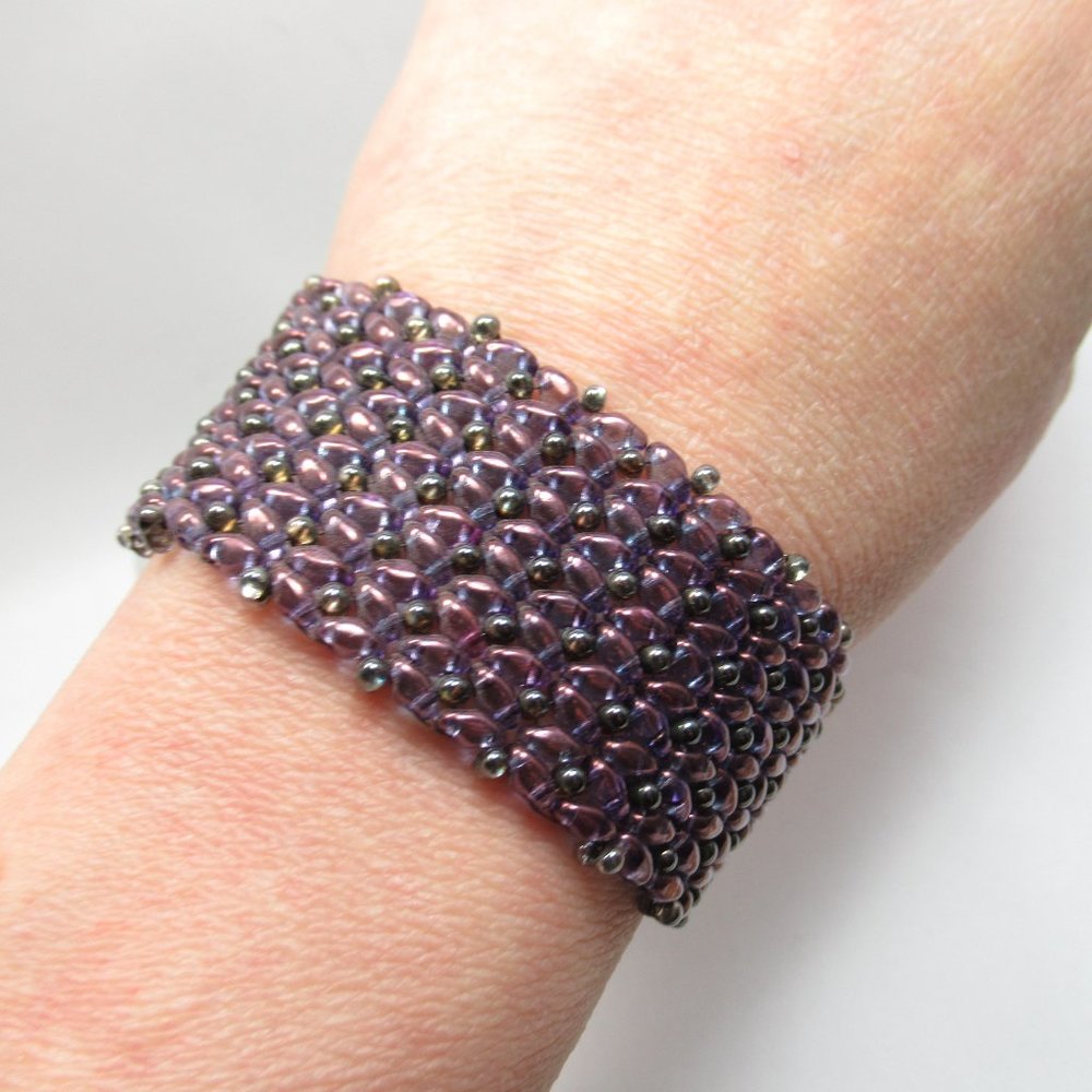 Handwoven transparent purple bracelet with metal button closure